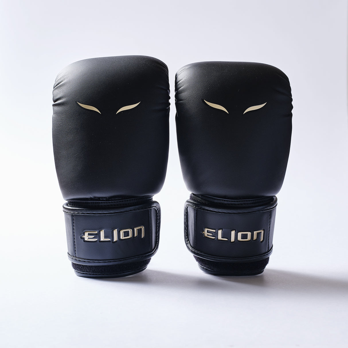 Elion Bag Gloves Black/Gold pair front with gold ELION logo