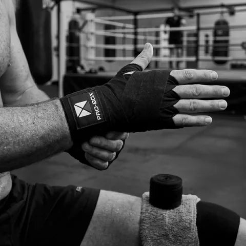 Boxer putting on Pro-Box hand wraps