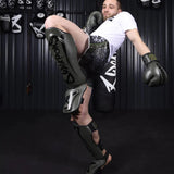 8 हथियार असीमित शिन गार्ड जैतून/काला