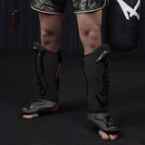 8 हथियार असीमित शिन गार्ड जैतून/काला