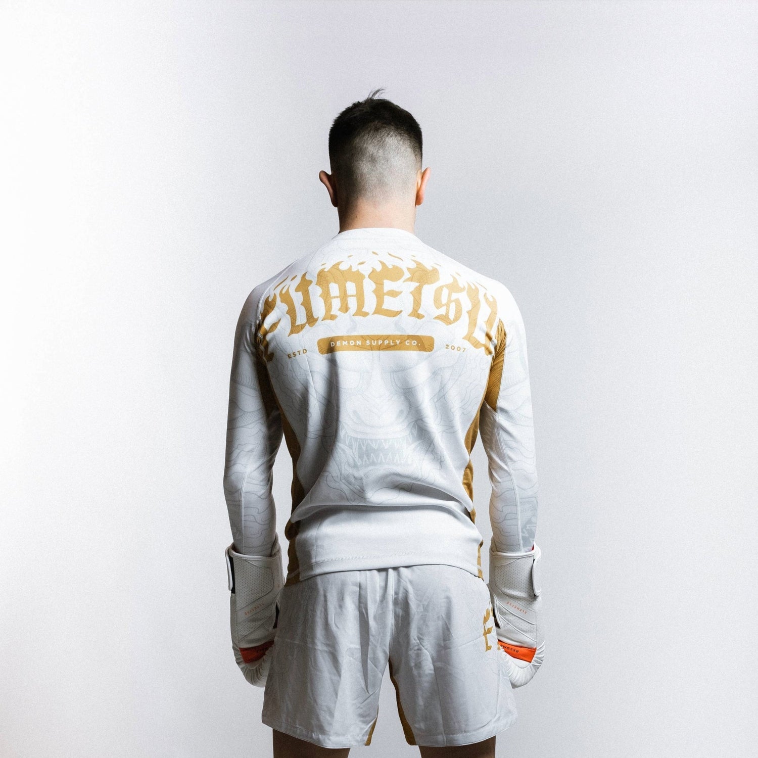 Fumetsu Oni Long Sleeve Rash Guard White/Gold/Grey from Made4Fighters