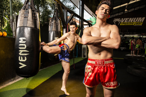 Muay Thai fighters in Venum shorts at a training camp