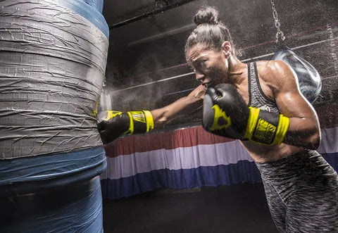 Boxer training with Ringhorns gloves on a heavy bag