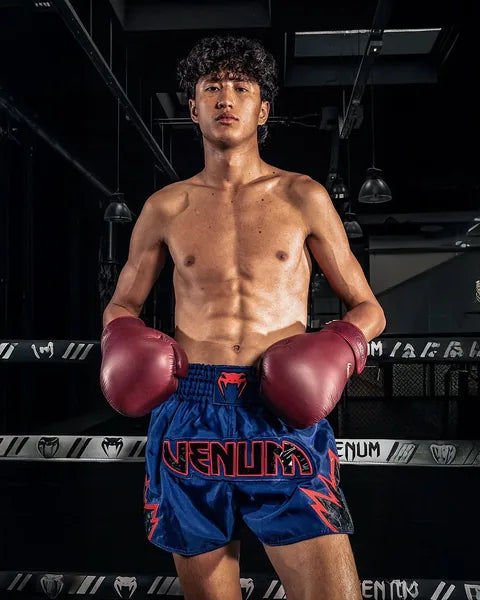 Venum athlete wearing boxing gloves in the ring